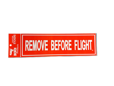 Rectangular red sticker with 'REMOVE BEFORE FLIGHT' text on a background
