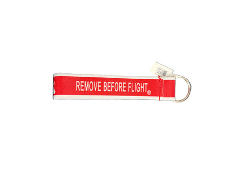 Red and white keychain with 'Remove Before Flight' text.